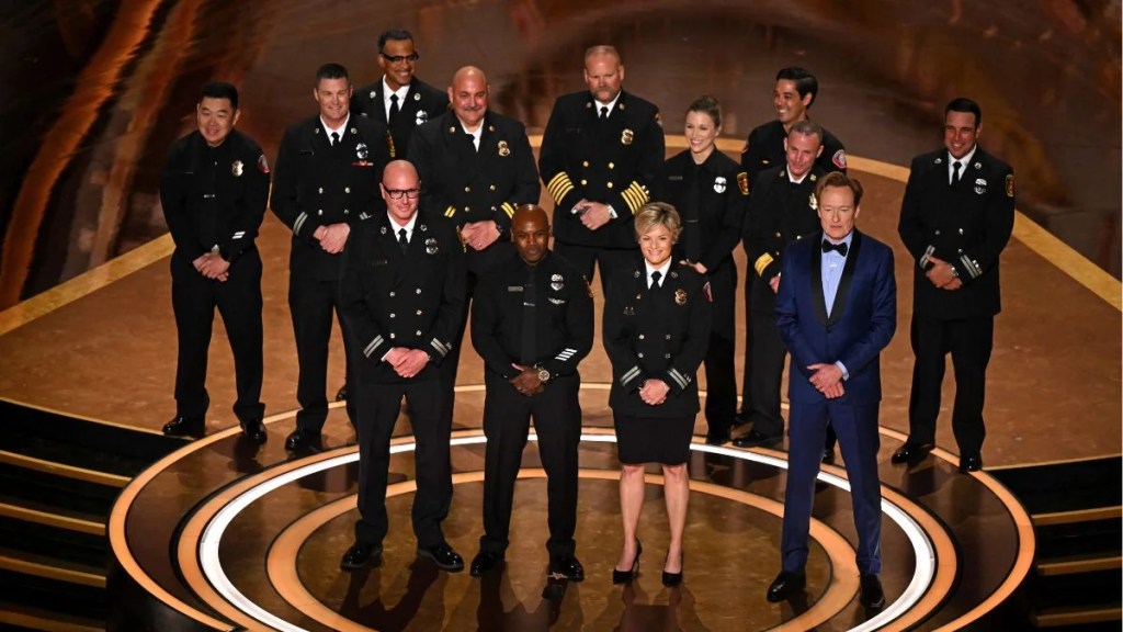 Los Angeles Fire Department (LAFD) Captain Erik Scott, LAFD helicopter pilot Jonith Johnson Jr. and Pasadena Fire Captain Jodi Slicker speak onstage next to US comedian and host Conan O'Brien during the 97th Annual Academy Awards at the Dolby Theatre in Hollywood (Getty Images)
